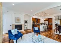 Bright living room with hardwood floors, fireplace, and access to backyard patio at 4553 Osceola St, Denver, CO 80212