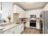 Modern kitchen with stainless steel appliances at 15700 E Jamison Dr # 8-103, Englewood, CO 80112