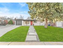 Updated Ranch home with modern gray and white exterior, landscaping, and red door at 195 Jade St, Broomfield, CO 80020