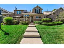 Brick two-story townhome with landscaping and walkway at 41 Quince St, Denver, CO 80230