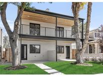 Two-story modern home with a covered balcony and landscaped yard at 1372 Perry St, Denver, CO 80204