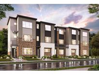 Modern three-story townhome development with brick and siding at 455 Interlocken Blvd # 104, Broomfield, CO 80021