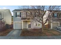 Two-story house with gray siding, attached garage, and a well-maintained front yard at 10706 Butte Dr, Longmont, CO 80504