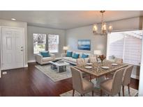 Living and dining area with hardwood floors and modern furniture at 5264 S Rome St, Aurora, CO 80015