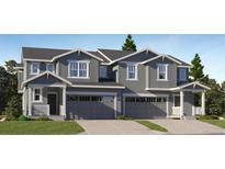 Charming two-story townhome with gray siding and attached two-car garage at 1381 Sunrise Dr, Erie, CO 80516