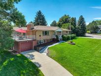Aerial view of a ranch-style home with a spacious yard and driveway at 9350 Grandview Ave, Arvada, CO 80002