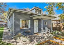 Gray house with a front porch, landscaping, and a walkway at 4219 Pecos St, Denver, CO 80211