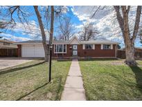 Brick ranch home with attached garage and landscaped yard at 3564 E Lake Dr, Centennial, CO 80121