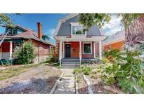 Brick home with front porch and landscaped yard at 638 S Lincoln St, Denver, CO 80209