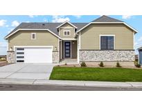 Tan house with white garage and landscaping at 42988 Colonial Trl, Elizabeth, CO 80107