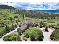 Luxury home nestled in the mountains with a circular driveway at 2916 Hiwall Ct, Castle Rock, CO 80109