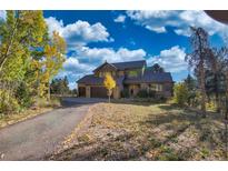 Two-story home with mountain views and autumn leaves at 10428 Christopher Dr, Conifer, CO 80433