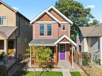 Brick two-story home with a purple door and front porch at 2725 California St, Denver, CO 80205