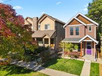 Two story townhome with a front porch and landscaped yard at 2725 California St, Denver, CO 80205