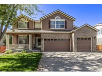 Two-story home with brick and siding, two-car garage, and landscaping at 11533 Dahlia St, Thornton, CO 80233