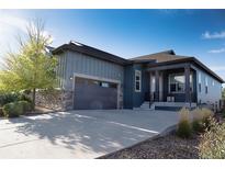 Modern two-story home with gray siding and a two-car garage at 3571 New Haven Cir, Castle Rock, CO 80109