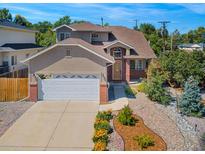 Charming two-story home with a landscaped front yard and attached garage at 3501 S Ivanhoe St, Denver, CO 80237