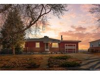 Ranch style home with brick facade, attached garage, and mature landscaping at 9210 Yucca Way, Thornton, CO 80229