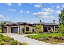 Luxury ranch home with stone accents and 3-car garage at 1210 Wildcat Bend Ct, Castle Rock, CO 80108