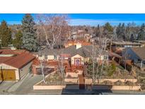 Aerial view of a ranch style home with large yard and deck at 4215 W Byron Pl, Denver, CO 80212