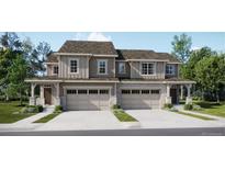 Two-story townhome with attached garage and attractive landscaping at 6699 Juniper Dr, Thornton, CO 80602