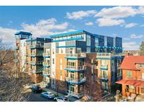 Modern multi-unit building with blue accents, balconies, and ample street parking at 1488 Madison St # 101, Denver, CO 80206