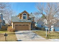 Two-story house with a two-car garage and landscaped yard at 11615 Masonville Dr, Parker, CO 80134