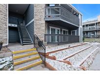 Exterior view of condo building with stairs and landscaping at 3480 S Eagle St # 101, Aurora, CO 80014