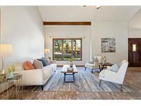 Spacious living room featuring hardwood floors and a cozy seating area at 6050 Belmont Way, Parker, CO 80134