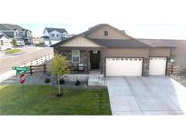 Two-story house with two-car garage and front porch at 108 Monarch St, Bennett, CO 80102