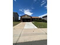 Ranch-style home with attached garage and driveway at 2125 S Telluride Ct, Aurora, CO 80013