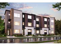 Modern three-story townhome building with brick and wood accents at 461 Interlocken Blvd # 101, Broomfield, CO 80021