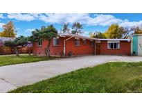 Brick ranch home with spacious driveway and landscaping at 4955 Howell St, Golden, CO 80403