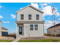 Two-story home with white siding, showcasing a charming and modern design at 3036 Oxley St, Strasburg, CO 80136