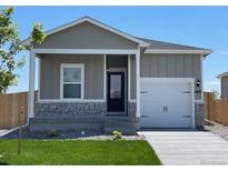 Charming house with gray siding, a white door, and a well-manicured lawn at 2420 Christina St, Fort Lupton, CO 80621