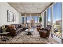 Spacious living room with floor to ceiling windows and city views at 891 14Th St # 3108, Denver, CO 80202