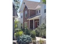 Two story home with brick and white siding at 8802 E 24Th Pl # 101, Denver, CO 80238