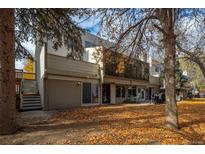 Back exterior of townhome with private patio and mature trees at 2362 S Troy St, Aurora, CO 80014