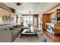 Spacious living room with hardwood floors, fireplace, and city views at 2001 Lincoln St # 1024, Denver, CO 80202
