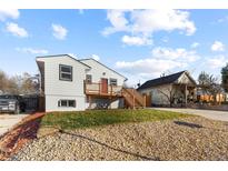 Newly renovated home with a deck and a well-manicured lawn at 800 Meade St, Denver, CO 80204