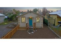 Front view of a charming house with a teal door at 3040 W 66Th Ave, Denver, CO 80221