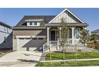 House exterior; two-story home with front porch and garage at 1097 Sunrise Dr, Erie, CO 80516