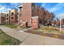 Brick building exterior with landscaping and a walkway at 301 Inverness Way # 209, Englewood, CO 80112