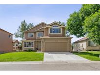 Two-story house with attached garage and landscaping at 9324 W Hinsdale Pl, Littleton, CO 80128