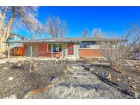 Brick ranch home with landscaped yard and stone pathway at 5442 S Cedar St, Littleton, CO 80120