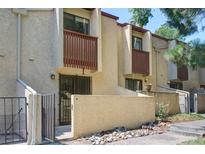 Tan stucco townhouse exterior with private patio and gated entry at 1060 S Parker Rd # 9, Denver, CO 80231