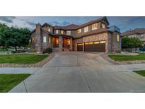 Two-story home with stone facade and a three-car garage at 15501 Fairway Dr, Commerce City, CO 80022