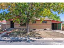 Brick ranch home with carport and mature landscaping at 7886 Cyd Dr, Denver, CO 80221