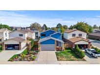 Aerial view of a charming blue house with a well-maintained yard at 11808 Sherman St, Northglenn, CO 80233