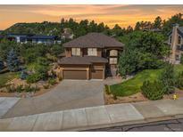 Two-story house with a three-car garage and landscaped yard at 525 Valley Dr, Castle Rock, CO 80104